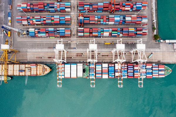 commercial dock loading and unloading cargo from container ship import and export transportation by crane. aerial top view