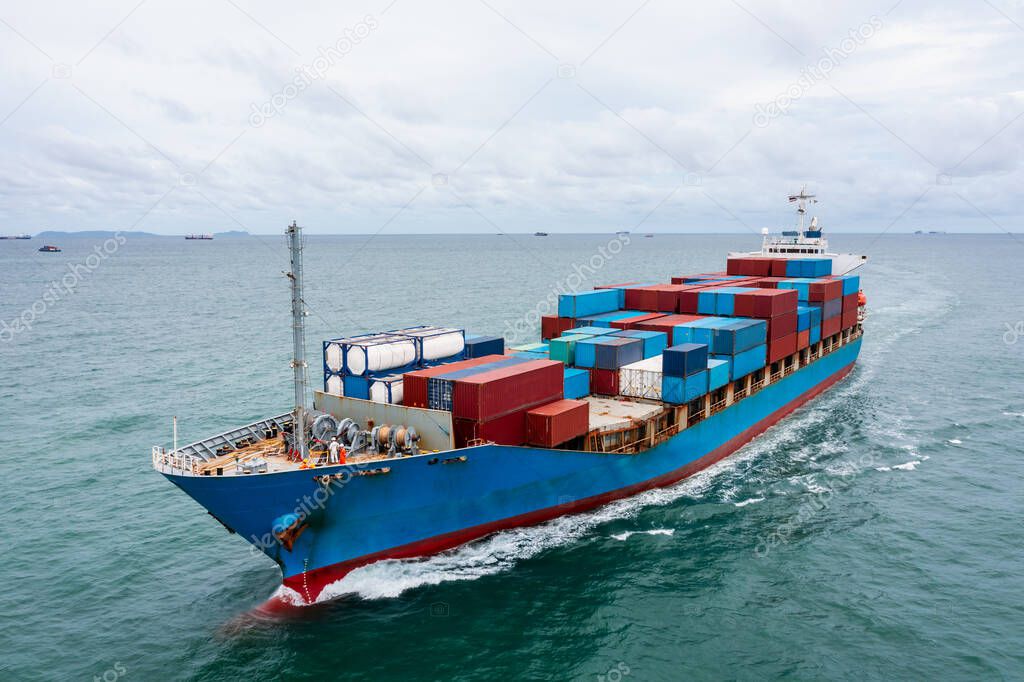 container cargo ship sailing full speed in green sea to transport of goods import export internationally or worldwide as business and industrial transport and marine services in open sea aerial  view from drone, shipping transporttation concept,