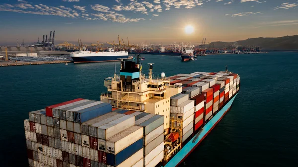 Aerial view container cargo ship carrying commercial container in import export business commerce logistic and transportation of international by container ship at morning over the sunlight international shipping port background