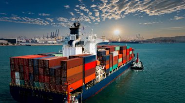 Uluslararası konteynır konteynırı ticari ticaret lojistik ithalatında ticari konteynır taşıyordu ve uluslararası taşımacılık konteynır gemisiyle güneş ışığı uluslararası liman arka planı üzerinden sabah 