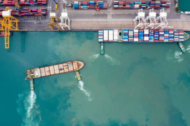 container ship and tug boat to quayside for load and unload container via crane for logistics, import export goods internationally around the world, including Asia Pacific and Europe, top view