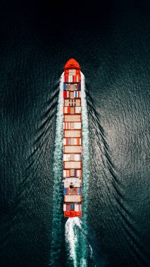 container ship sailing full speed to transport goods logistics in containers for import export internationally and worldwide, business services transportation by container ship open dark sea, aerial top view from drone,