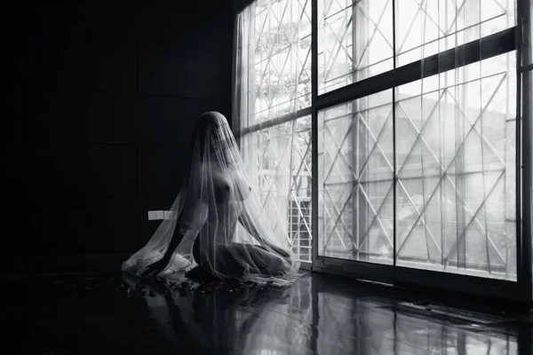 black and white young asian women model sitting poses naked by the window light only a thin curtain envelops her and dark background, lady sexy emotion of art concept,