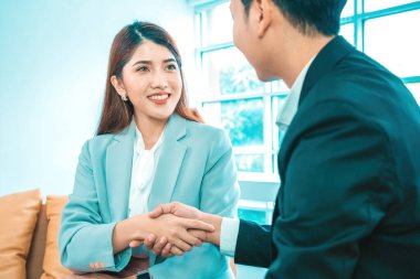 İş adamları el sıkışıyor. Takımımıza hoş geldin! Günümüz modern erkek ve kadınları yaratıcı ofiste çalışırken el sıkışırlar.