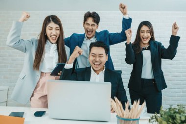 Takım çalışmasının başarısını, iş başarısını kutlayan çeşitli çalışanlar. Bir grup başarılı iş adamı ofiste takım olarak çalışıyor..