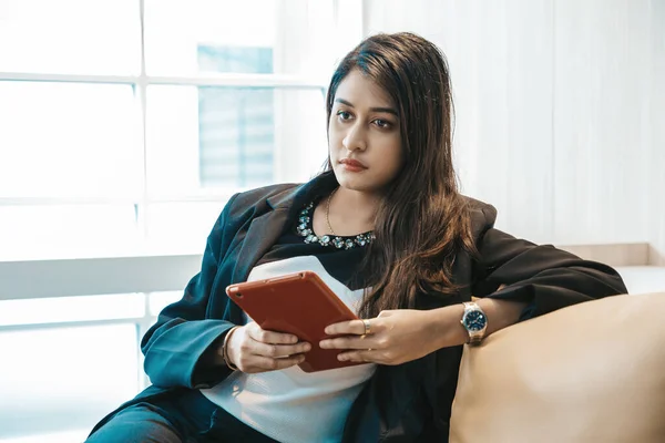 Young indian female business woman thinking in office, serious hindu manager thinking about new project in office.