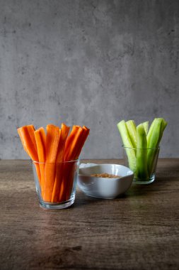 Taze salatalık ve havuç kavanozlarda izole edilmiş gri arka plan, kopyalama alanı, vegan, dikey foto