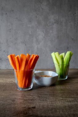 Taze salatalık ve havuç kavanozlarda izole edilmiş gri arka plan, kopyalama alanı, vegan, dikey foto