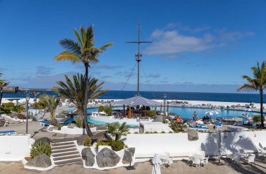 PUERTO DE LA CRUZ, TENERIFE - 9 Nisan 2022: Turistler Tenerife 'deki Puerto de la Cruz' daki Lago Martianez halk tuzlu su havuzlarında güneşin tadını çıkarıyorlar - İspanyol Kanarya Adaları 'nın en büyüğü.