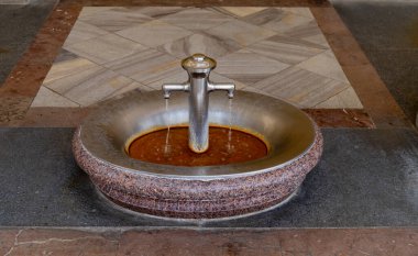 Karlovy Vary, Czech Republic - Hot mineral water spring in the Mill Colonnade building, a large historical colonnade with several hot springs in this spa town. Selektive focus.