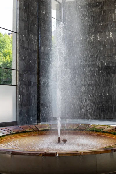 Karlovy Vary, Bohemia, Czech Republic - August 6, 2022, The Fontana Vridlo Sprudel or Vridlo Fountain in the colonnade of the hot spring or Vridelni Kolonada in Karlovy Vary.