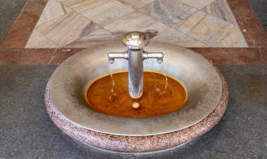 Karlovy Vary, Czech Republic - Hot mineral water spring in the Mill Colonnade building, a large historical colonnade with several hot springs in this spa town. Selektive focus.