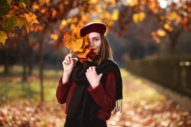 Autumn portrait of happy young woman wearing a sweater and french beret