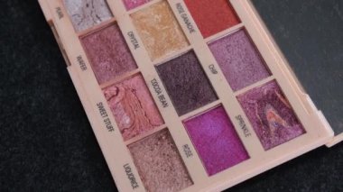Eye shadow palette close-up and makeup brush. Close up shot. High quality 4k footage.