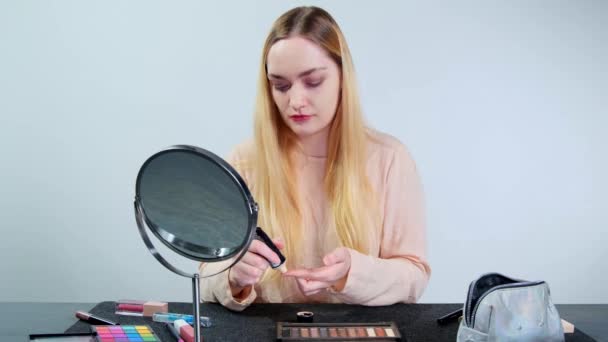 Young Blonde Woman Applying Foundation Her Face Doing Makeup Studio — Stockvideo