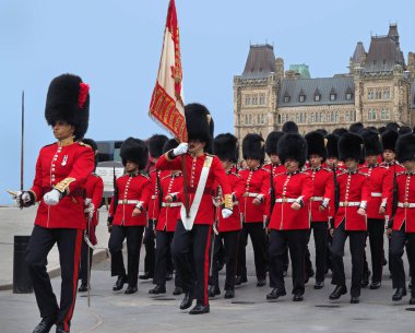 OTTAWA - AUGUST 2018:  There is a colorful daily changing of the guard ceremony in front of the Canadian Parliament building, with guards in uniforms in the British royal tradition. clipart