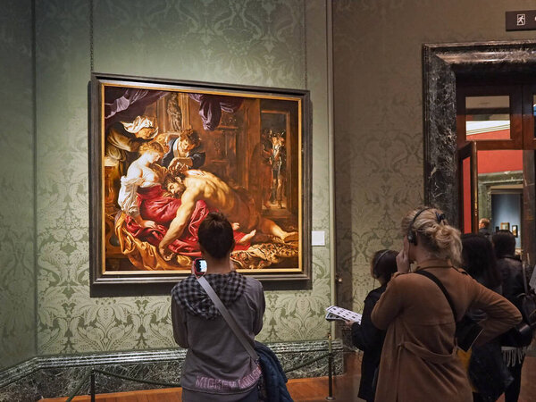 London, England - September 27, 2016:  A tour group of visitors admire the old masters at the National Gallery, such as Samson and Delilah by Peter Paul Rubens.