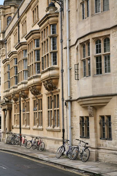 Bicycles Sidewalk Leaning Old Stone College Building — 스톡 사진