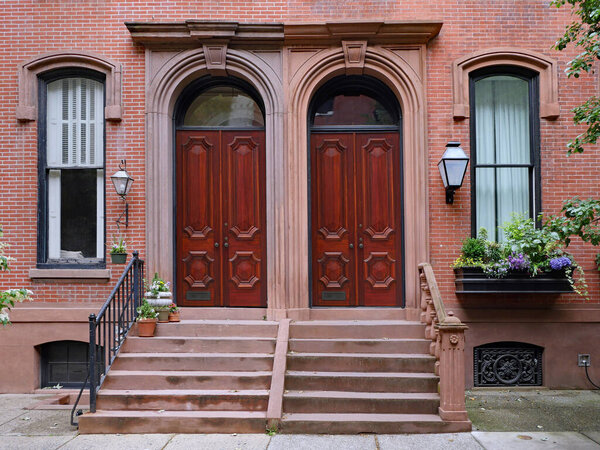 Brownstone style apartments with elegant double wooden mahogany front doors