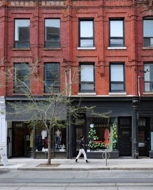 Toronto, Ontario, Canada - May 6, 2022:  Older neighborhoods of Toronto such as Queen Street West preserve independent stores that have real character