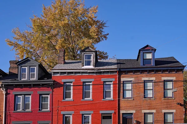 Old brick houses with dormer windows painted in cheerful colors