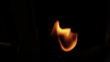 A fire flame burns in oil pot with some beautiful orange reflections in slow motion. High quality FullHD footage, Recorded by Fujifilm XT4