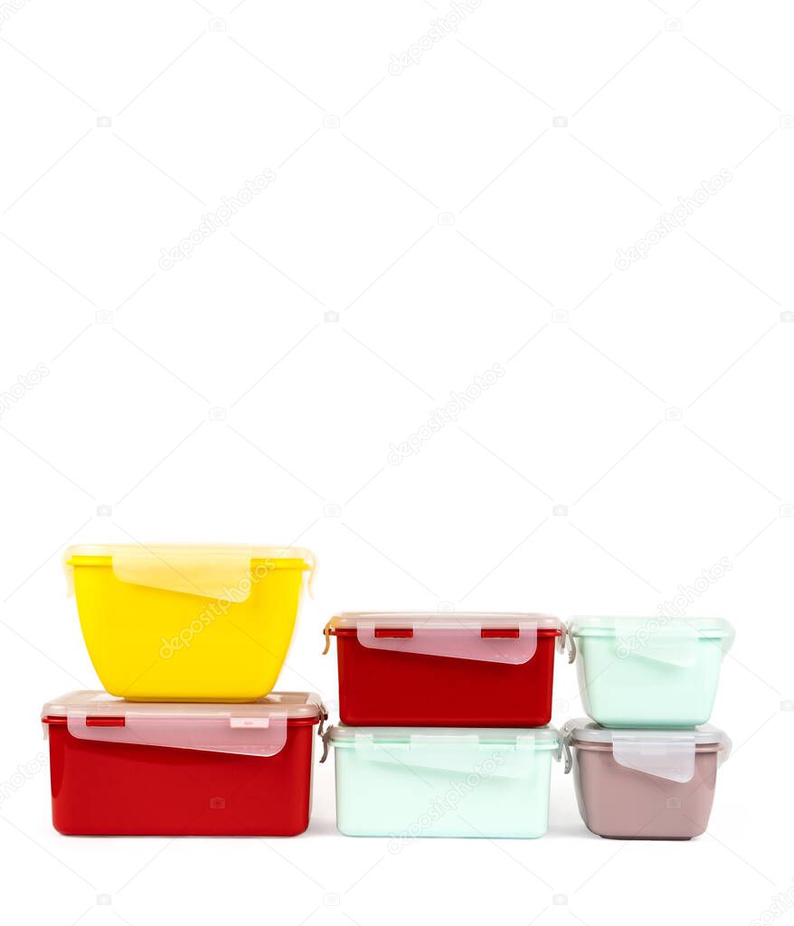 A set of multi-colored plastic containers for storing food and having a snack at any time. Isolated on white with place for text.