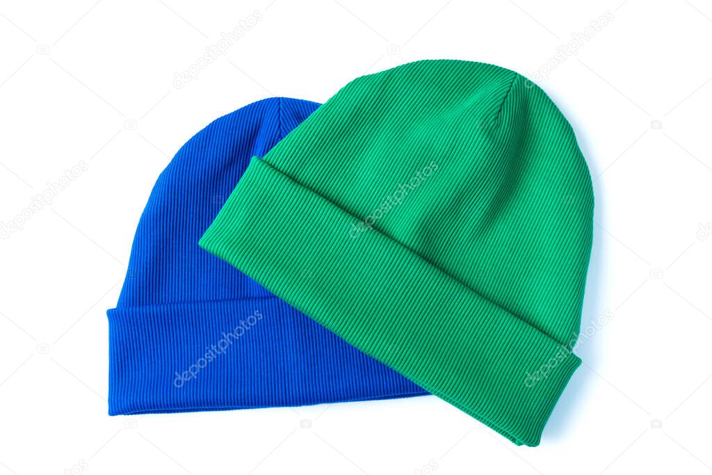 Two stylish youth beanie hats in trendy colors green and bright blue for cool weather