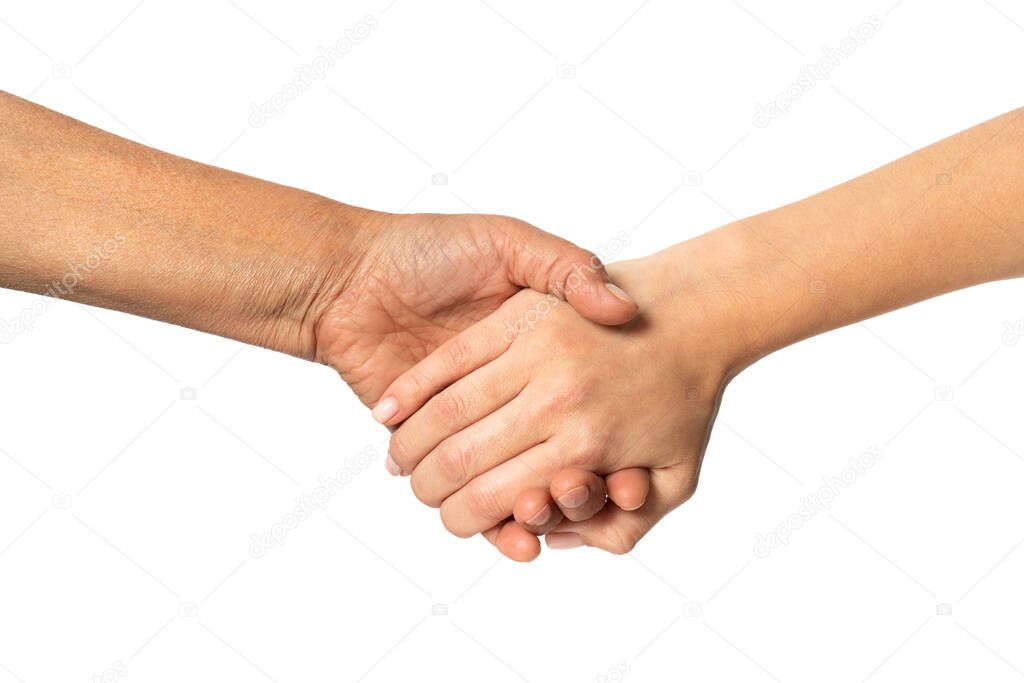 Elderly and young girls holding hands close-up. Help and frendly concept