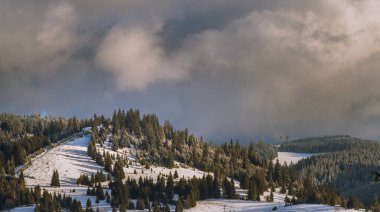 Kış, yüksek dağlarda kar beyazı zirveler. Yeri Carpathian, Vatra Dornei, Bucovina, Suceava, Romanya, Avrupa. Günbatımı. Kış ormanı Misafir evi