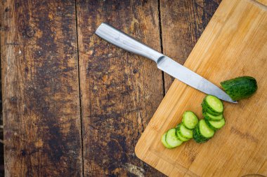 Kırsal ahşap arka planda taze salatalık. Salatalıklar düşük kalorilidir ama birçok önemli vitamin ve mineralde kilo kaybeder. Yaprak ve çiçek