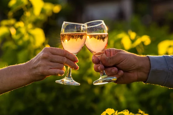 Toasting with two glasses of Champagne in the vineyard, Toasting with four glasses of Champagne in the vineyard, at sunset, rose, Silhouette, Cropped Hands, raise a toast, Cheers, rural, peasantry