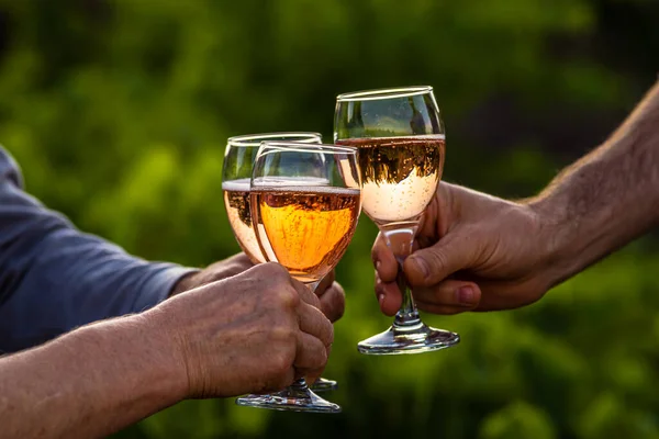 Toasting with two glasses of Champagne in the vineyard, Toasting with four glasses of Champagne in the vineyard, at sunset, rose, Silhouette, Cropped Hands, raise a toast, Cheers, rural, peasantry