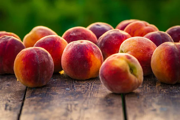 Group fresh peaches wood TABLE green natural background, (Prunus persica)  Harvest for food Delicious outdoors sunny day, Fresh ripe leaf, summer sunny garden juicy organic  sweet fruit, vegan food sunrise