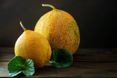fresh Whole and sliced of Japanese melons, honey melon cantaloupe (Cucumis melo) leaf wooden table background. fruit summer Fruits healthcare concept. dark Food backdround Still Life squash