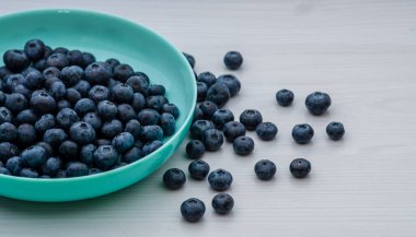 Fresh Blueberries blueberry BowlTable Freshly picked turquoise bowl. Juicy and fresh blueberries Bilberry white wood food Background. antioxidant. Concept healthy eating nutrition fruit  top view.