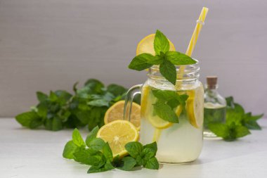 Mojito cocktail or mocktail with lemon, mint, and ice honey in glass jar Summer cold alcoholic non-alcoholic drink, beverage Copy space table