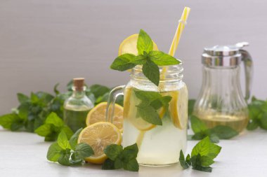 Mojito cocktail or mocktail with lemon, mint, and ice honey in glass jar Summer cold alcoholic non-alcoholic drink, beverage Copy space table