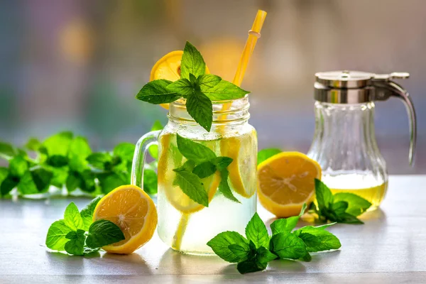 Mojito cocktail or mocktail with lemon, mint, and ice honey in glass jar Summer cold alcoholic non-alcoholic drink, beverage Copy space table