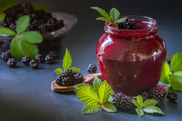 Tasty blackberry jam fresh berries, table raw Fresh homemade  green leaves Berries organic harvest forest still life glass jar wood spoon Dark background