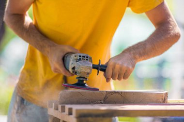 Close up of sanding a wood with orbital sander at workshop electric sander carpenter refining the surface
