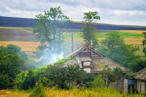 old village  house summer scenic landscape  green  smoke fire roof carcinogenic asbesto countryside Moldova poor