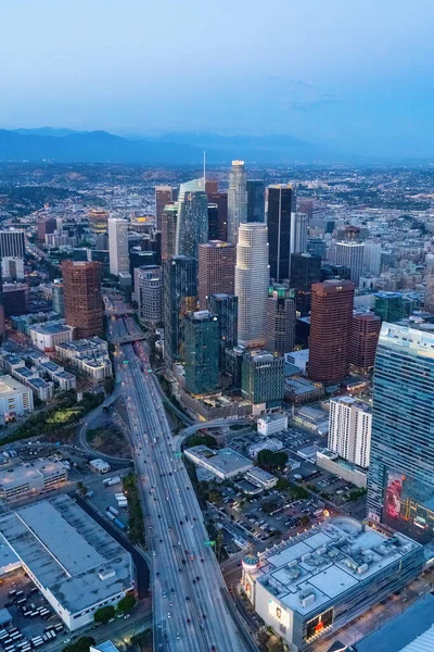 The downtown Los Angeles California and the city traffic at dusk. Picture taken from a helicopter after the sunset