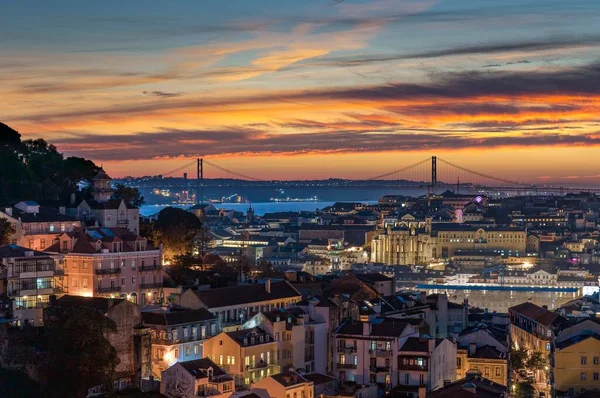 Sunset view of Bridge of 25th April and National sanctuary of Cristo Rei in Lisbon, Portugal. High quality photo