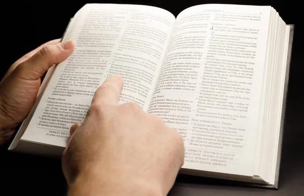 The hands of a man holding the bible while studying it — Stock Photo, Image