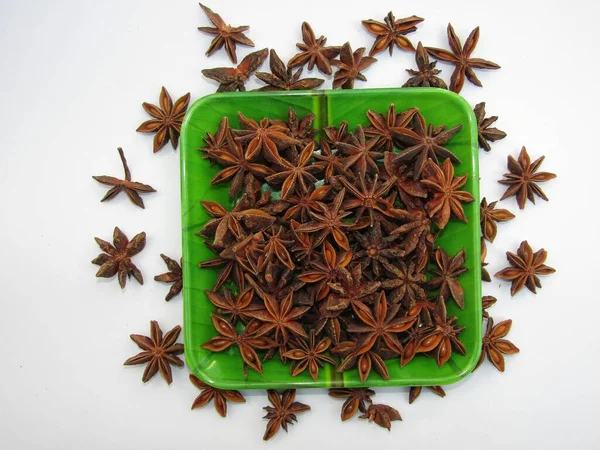 Star anise in a plate on white background