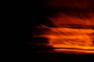 Red orange fire flame in motion on black background