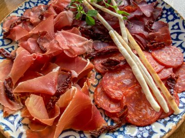Italian  Platter cold meat plate. Beautifully desingned buffet table in the restaurant with sliced meat on plate.