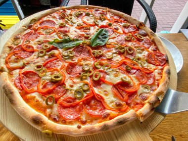 Restaurant Menu - Delicious Fresh Pizza. Pizza on Rustic Wooden Table with Ingredients. Tasty italian pizza.
