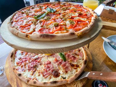 Restaurant Menu - Delicious Fresh Pizza. Pizza on Rustic Wooden Table with Ingredients. Tasty italian pizza.